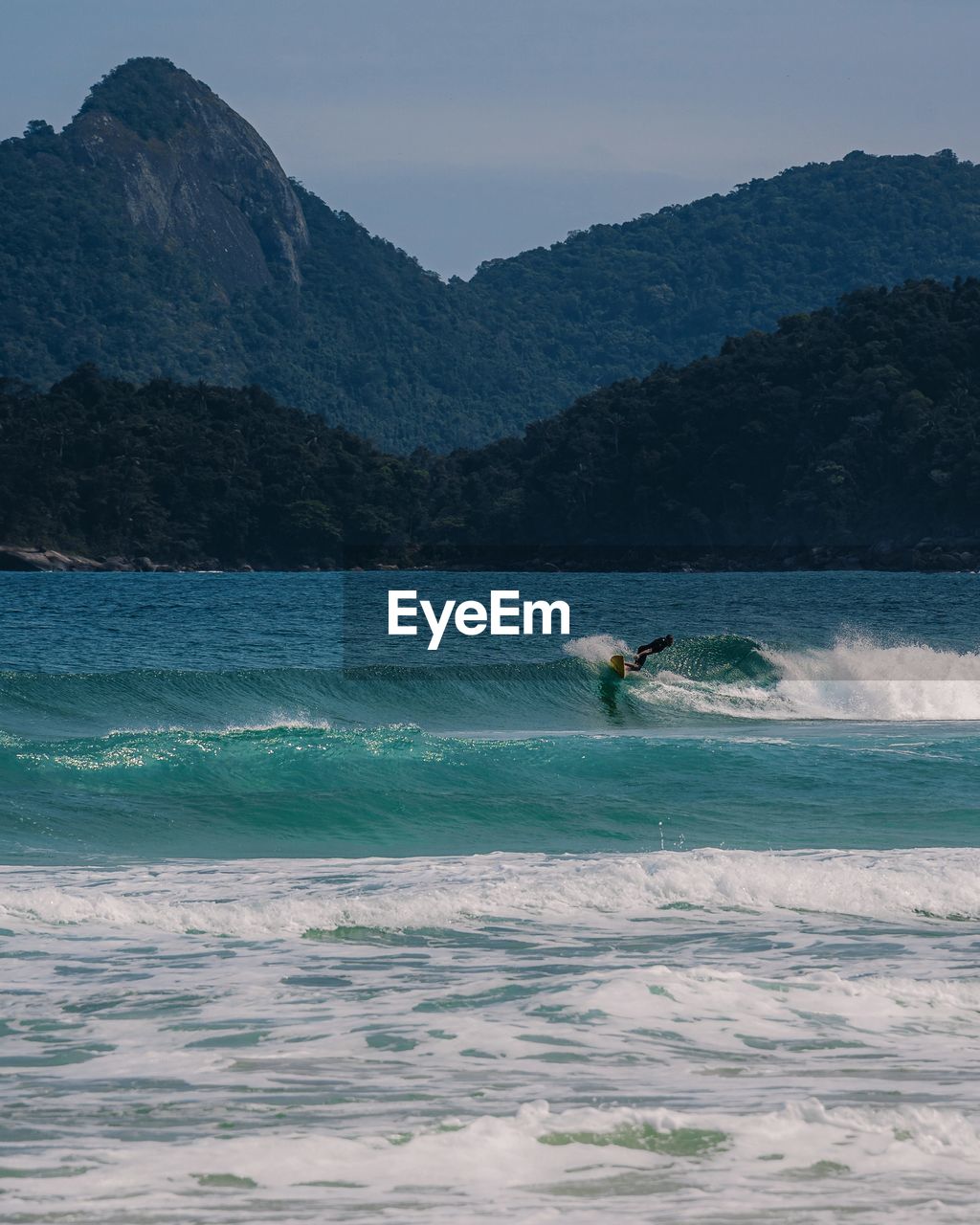 Scenic view of sea and mountains against sky