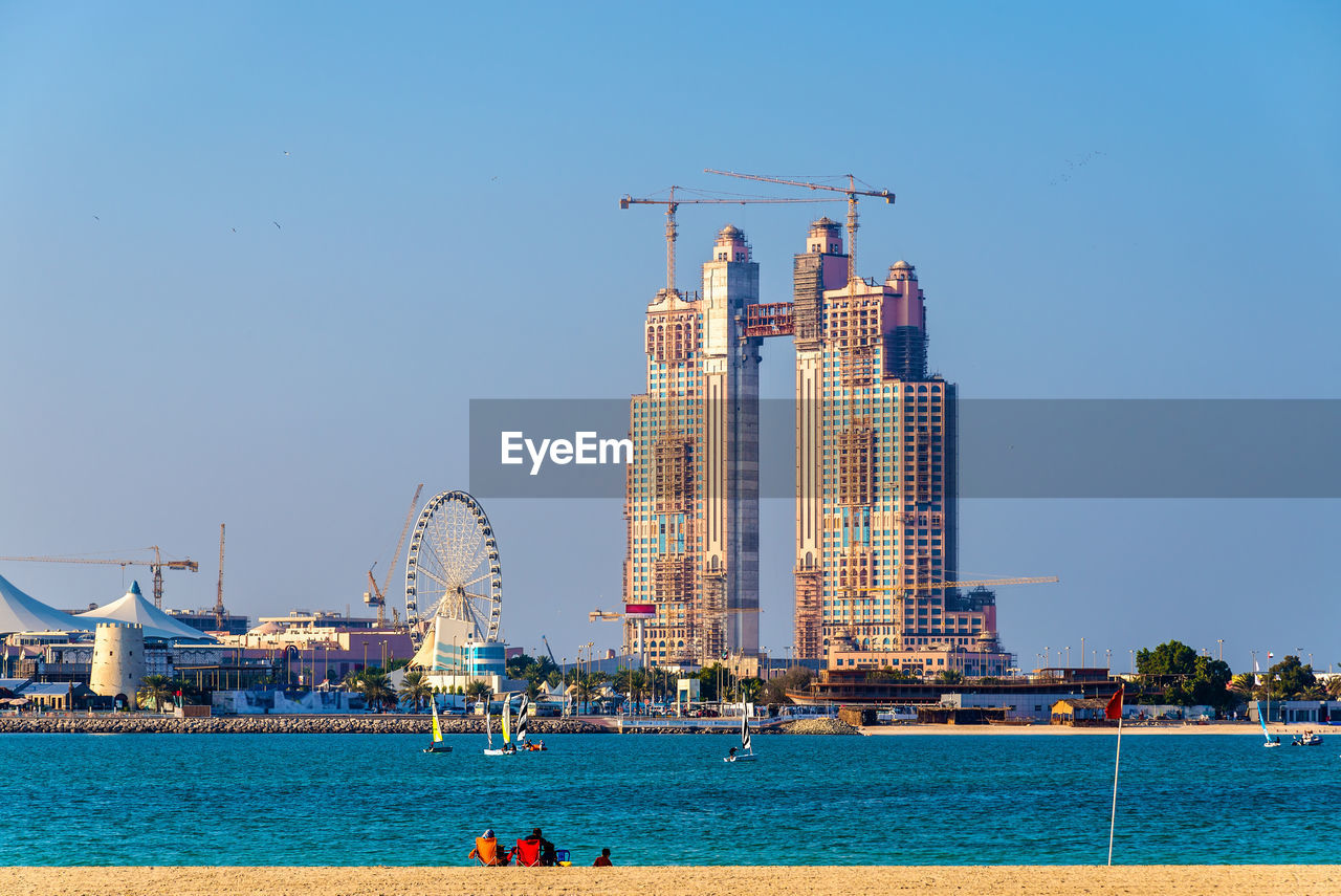 SEA AND BUILDINGS AGAINST CLEAR SKY