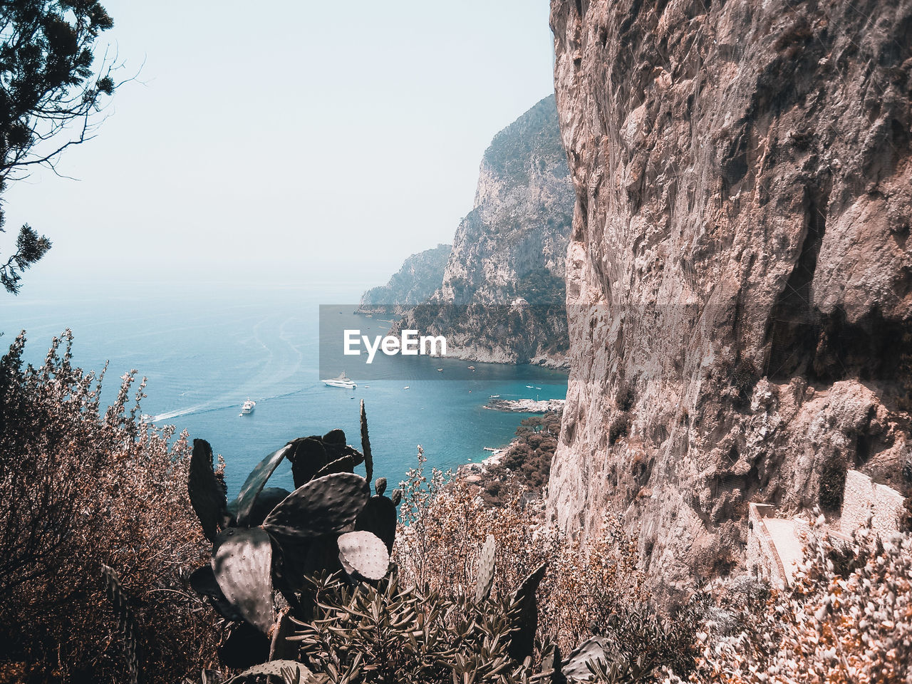 PANORAMIC SHOT OF ROCKS IN SEA