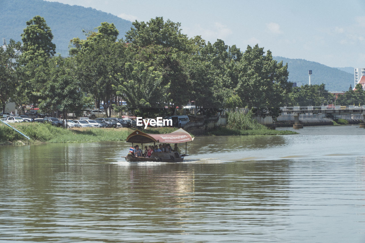 BOAT IN RIVER AGAINST SKY