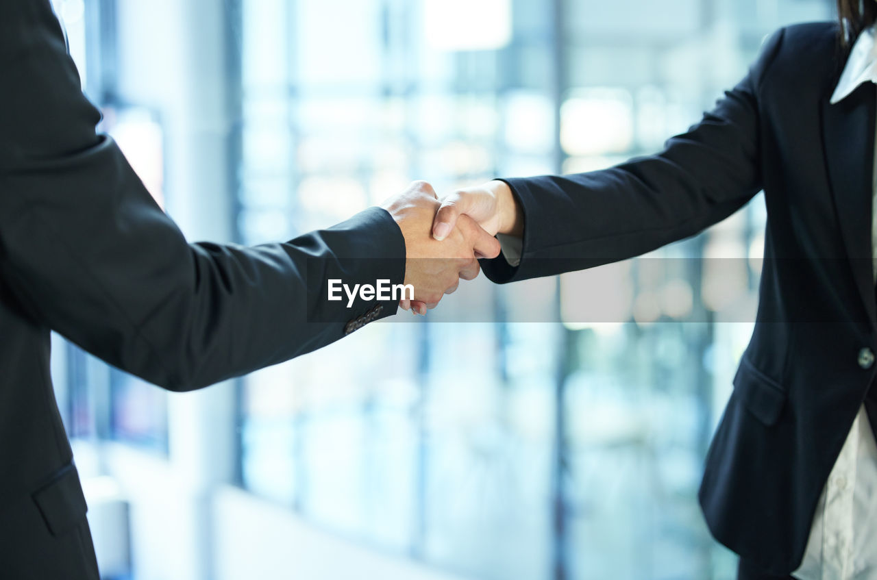 business colleagues shaking hands in office