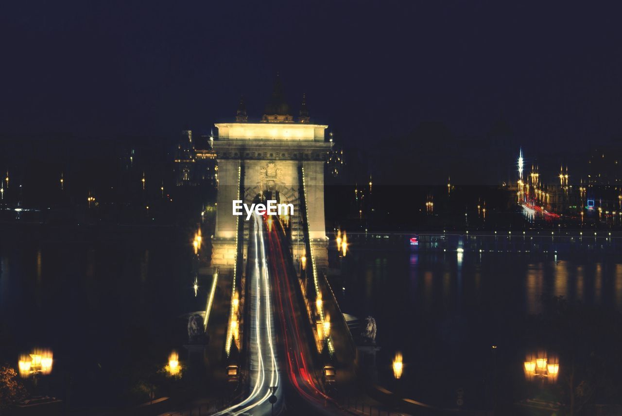 VIEW OF ILLUMINATED CITY AT NIGHT