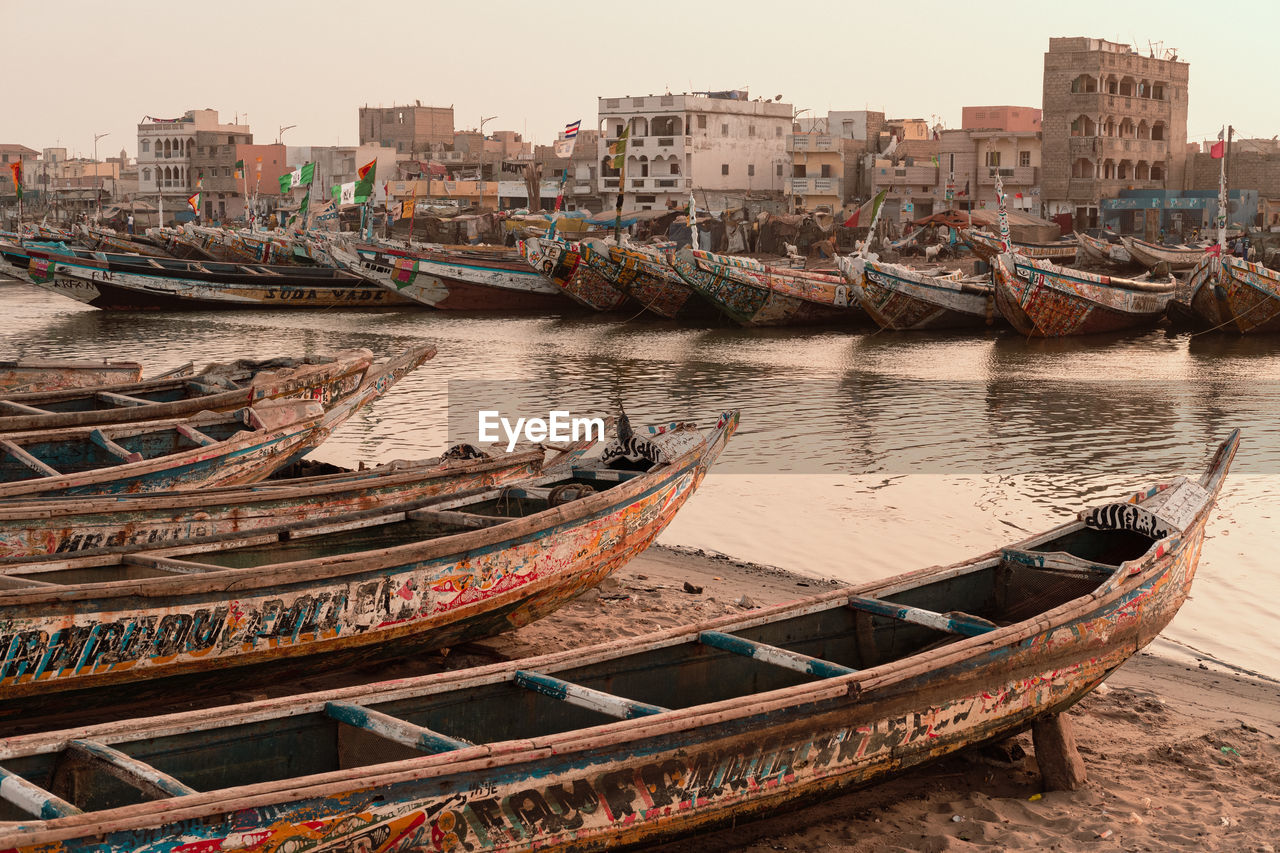 Colourful canoes on senegal river banks on sunset 