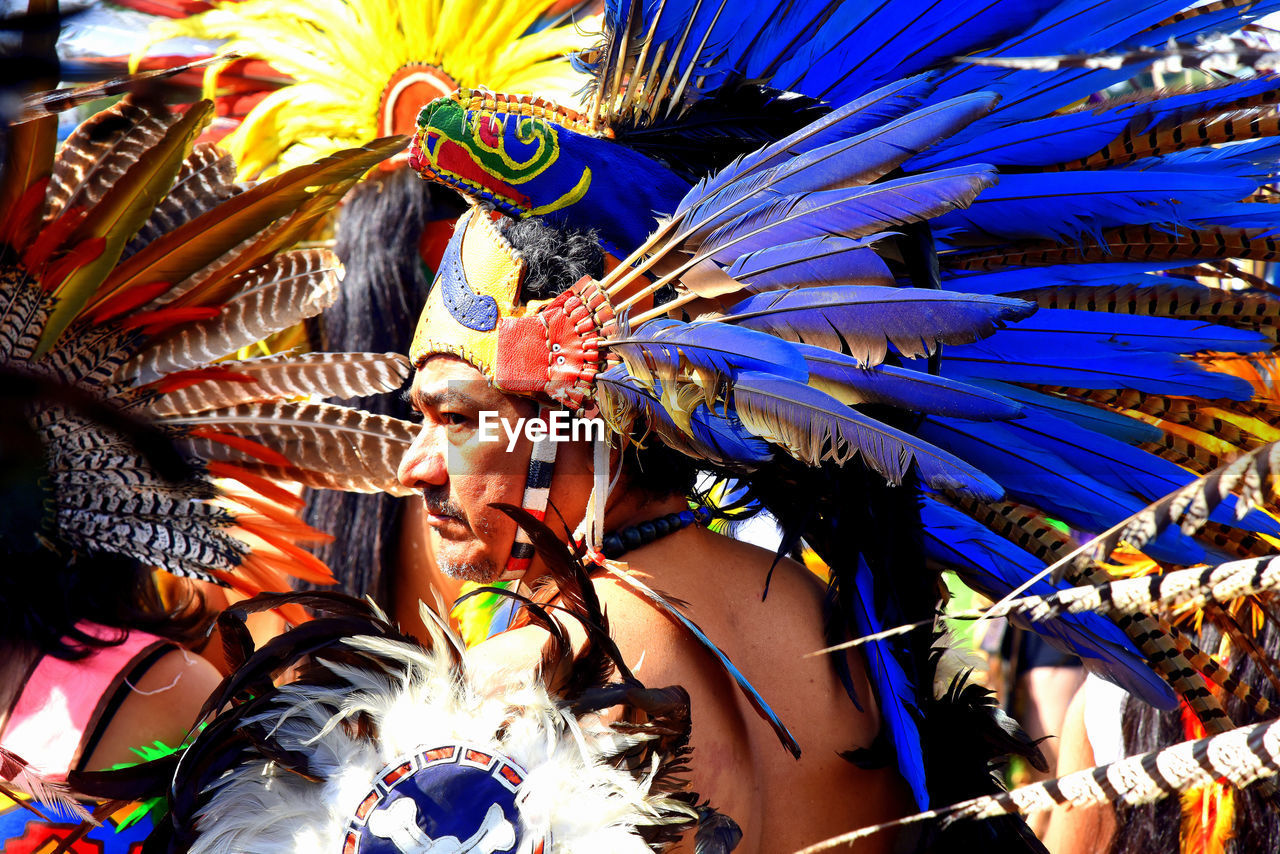 Close-up of man wearing multi colored headwear