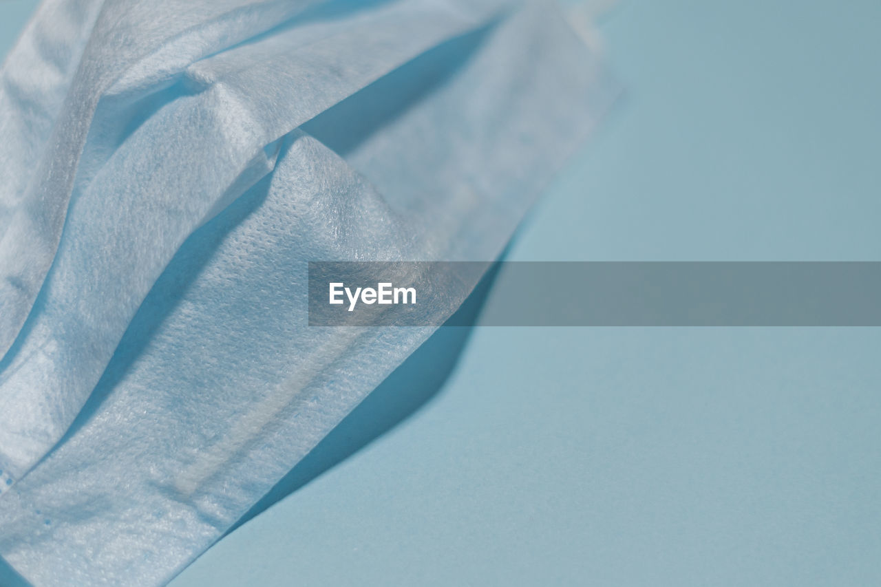 HIGH ANGLE VIEW OF BLUE PAPER