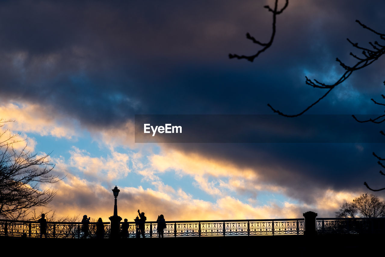 SILHOUETTE PEOPLE AGAINST SKY DURING SUNSET