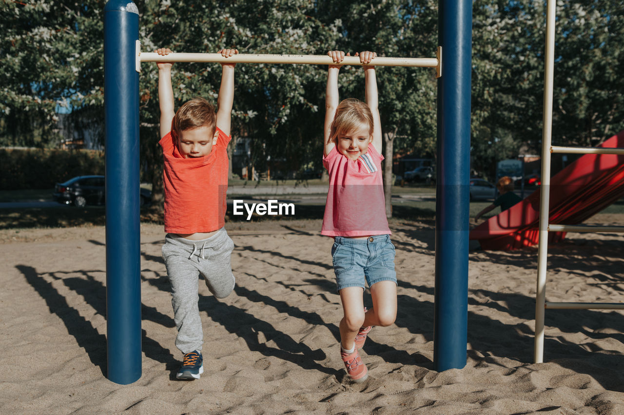 Full length of kids playing at playground