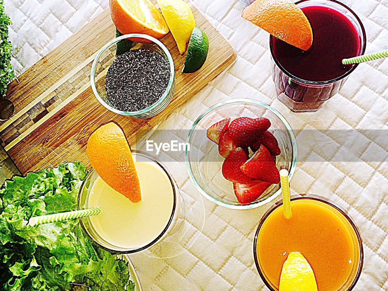 High angle view of juices and fruits on table