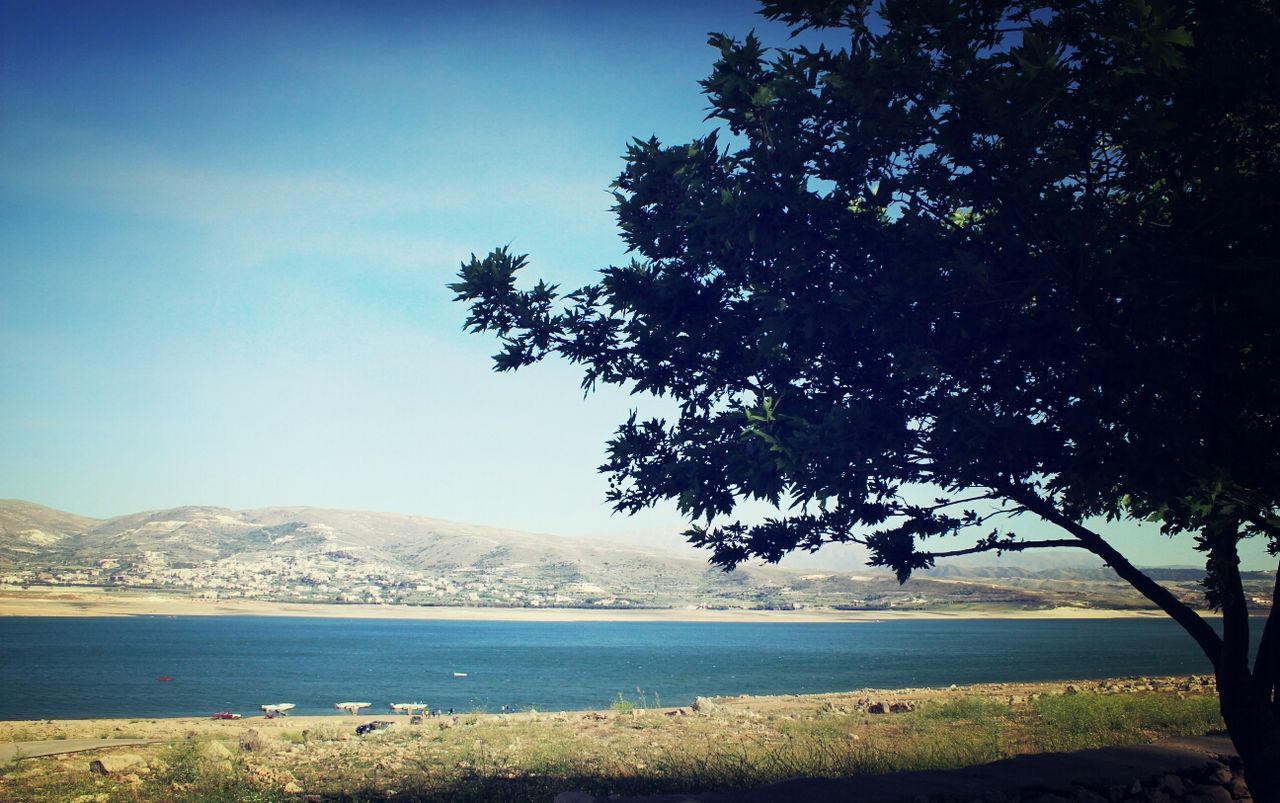 Calm countryside lake against blue sky