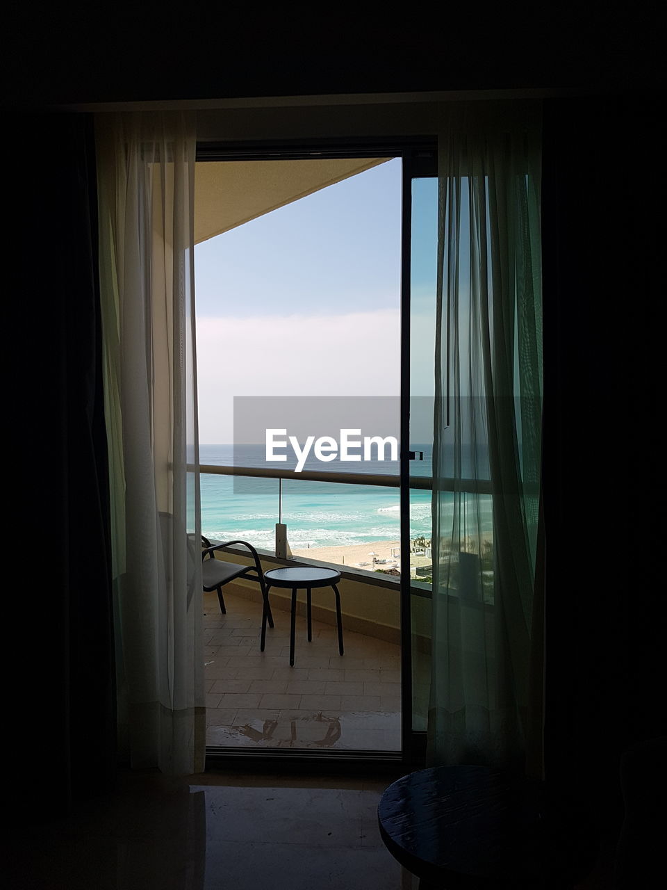 SCENIC VIEW OF SEA SEEN FROM WINDOW