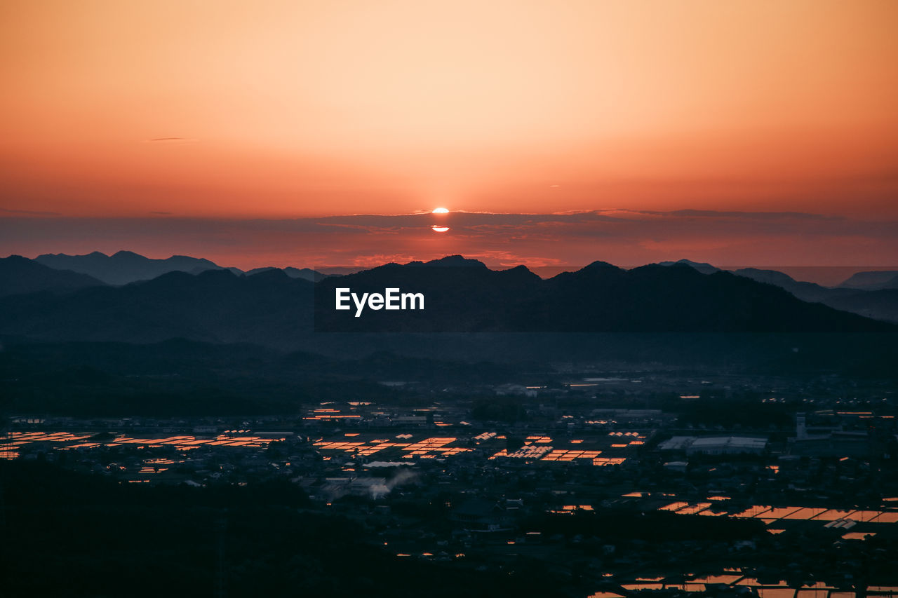 Scenic view of silhouette mountains against sky during sunset