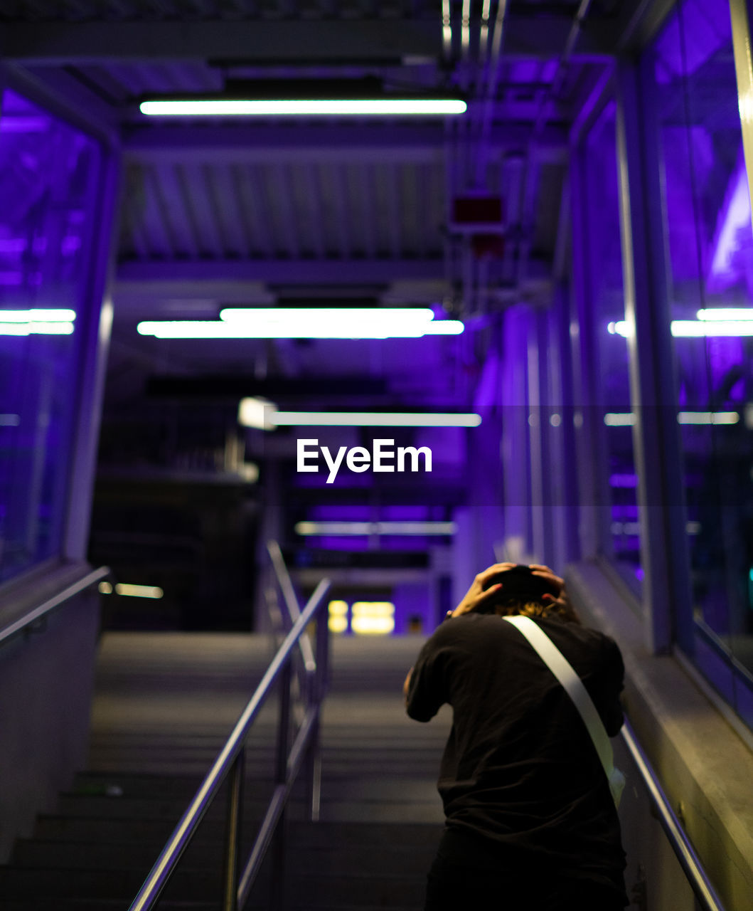 Rear view of woman standing at subway station