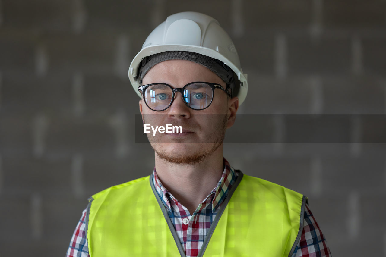 Portrait of young man wearing sunglasses standing outdoors