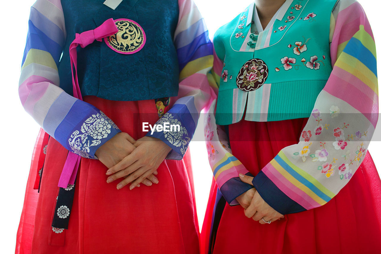 Midsection of women wearing traditional korean wedding dresses