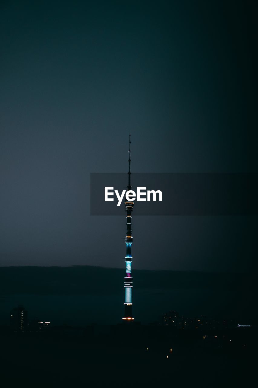 Communications tower against sky at night