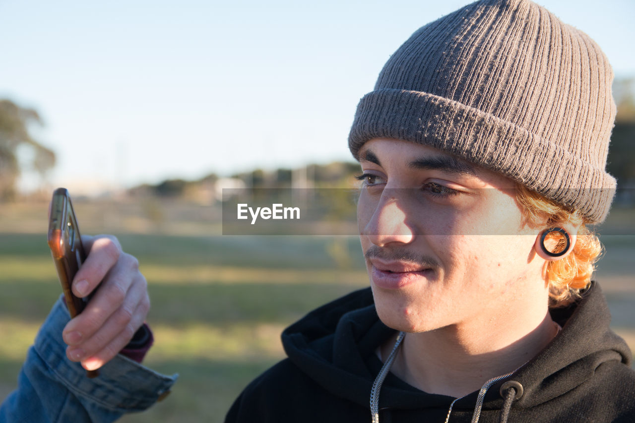 Portrait of young man wearing hat outdoors