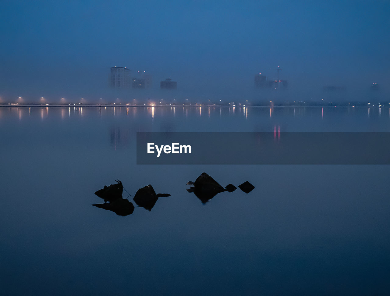 Scenic view of sea against sky at night
