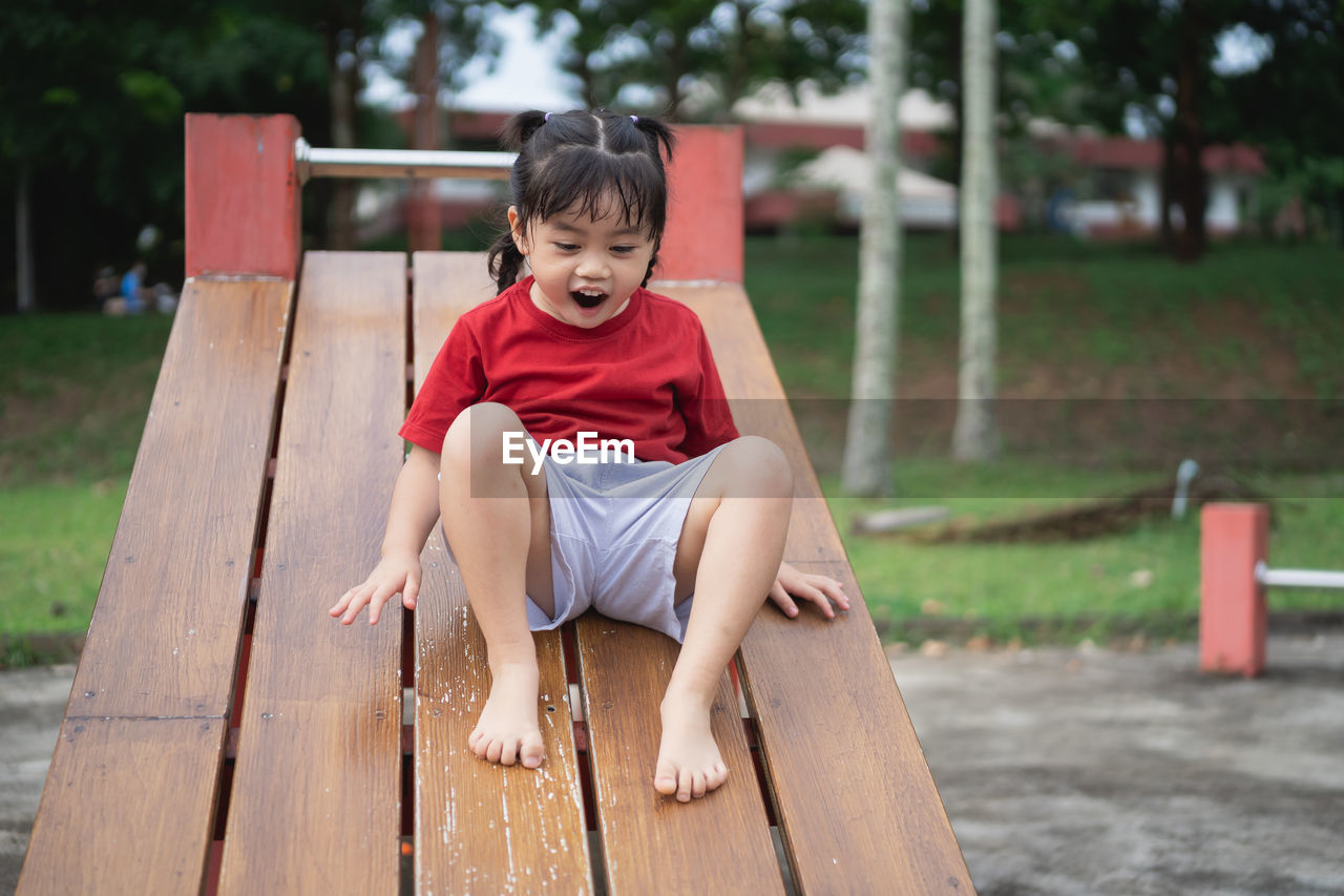 portrait of boy sitting on bench