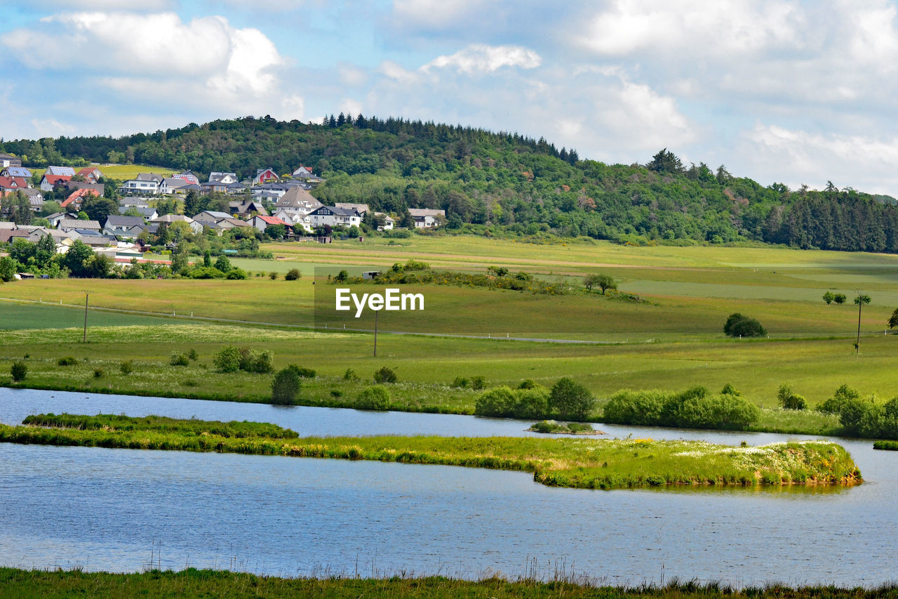 Scenic view of agricultural landscape against sky