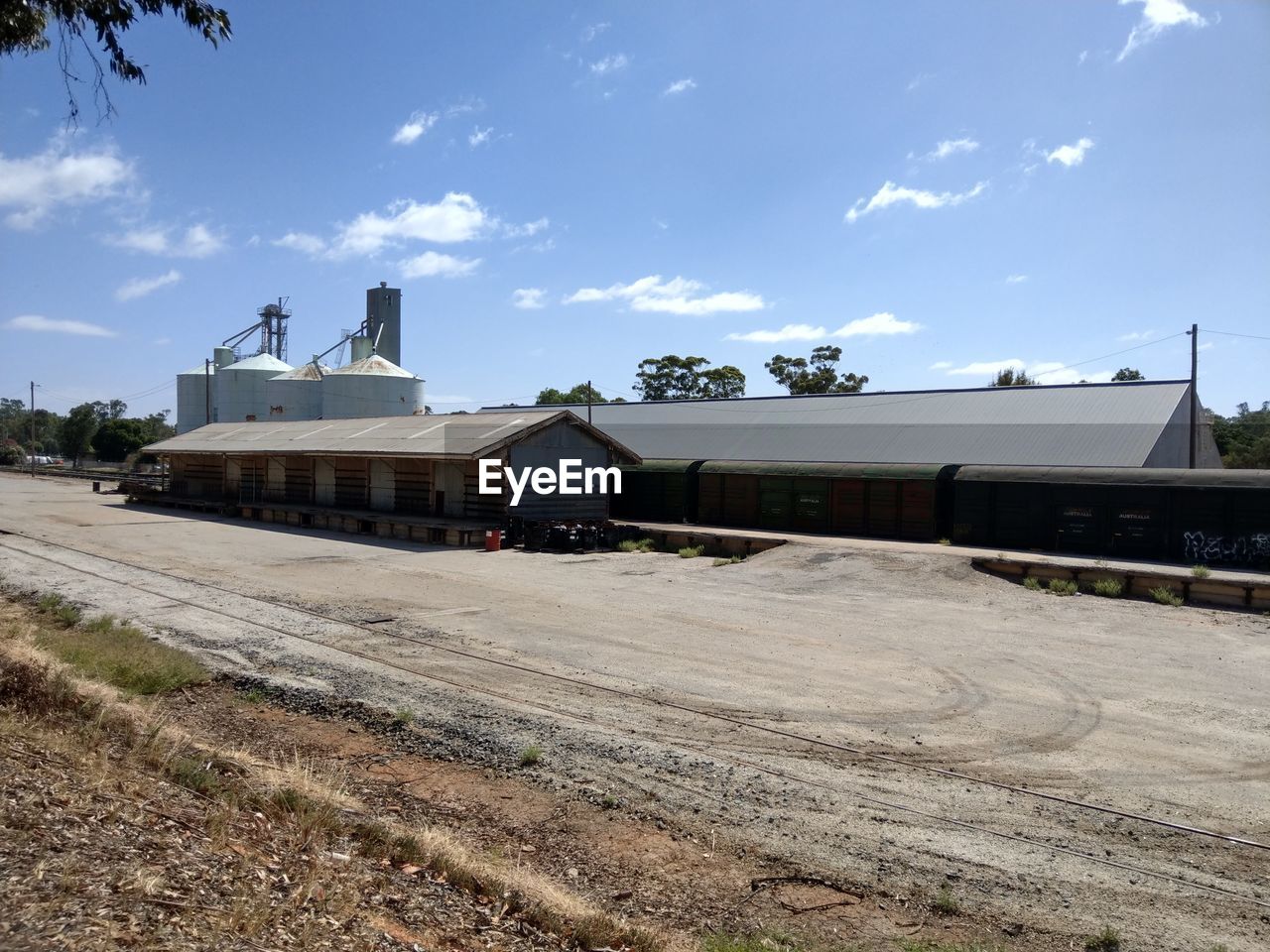 TRAIN ON RAILROAD TRACKS AGAINST SKY