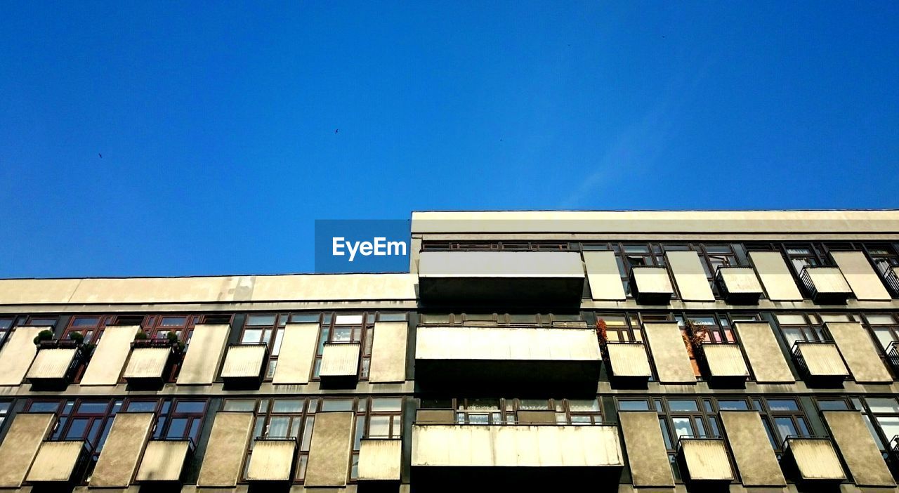 Low angle view of building against clear blue sky