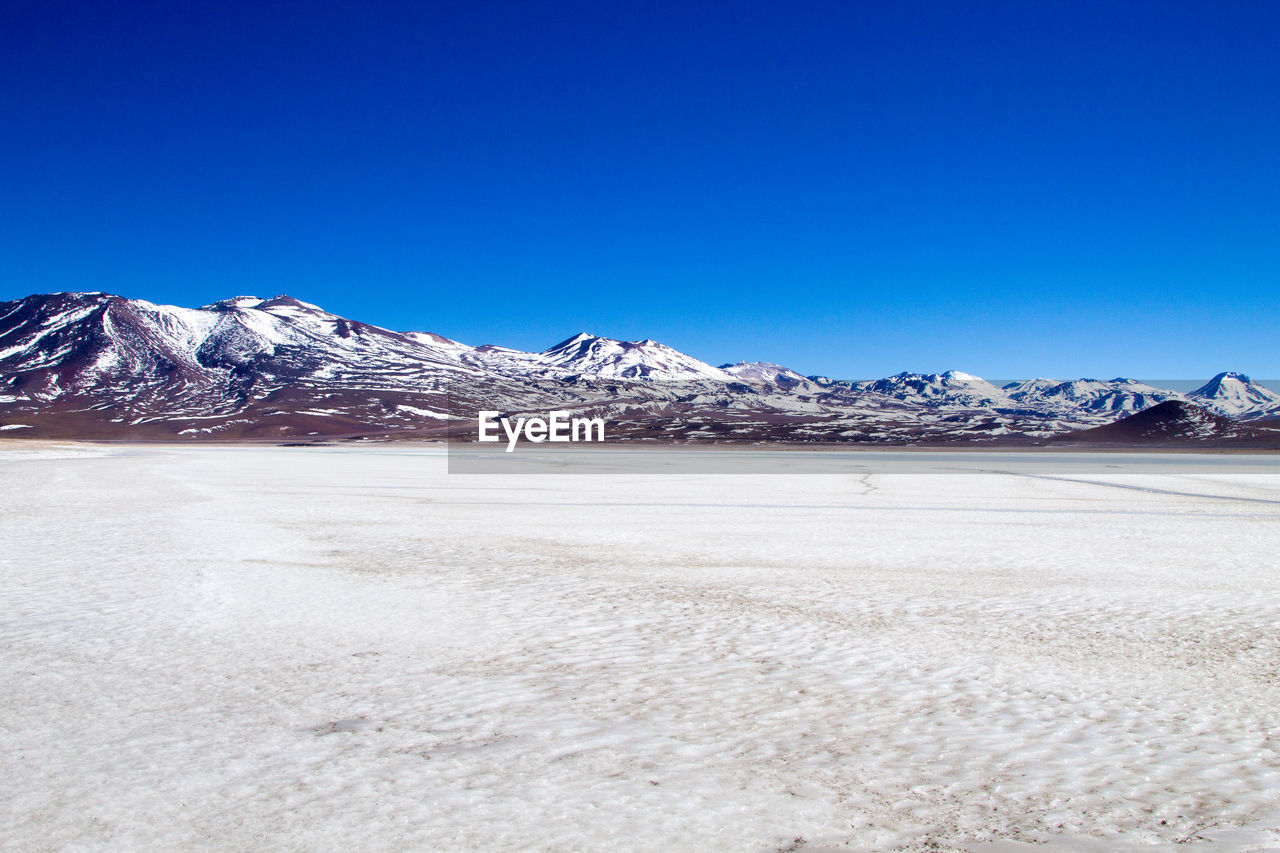 SNOWCAPPED MOUNTAINS AGAINST BLUE SKY