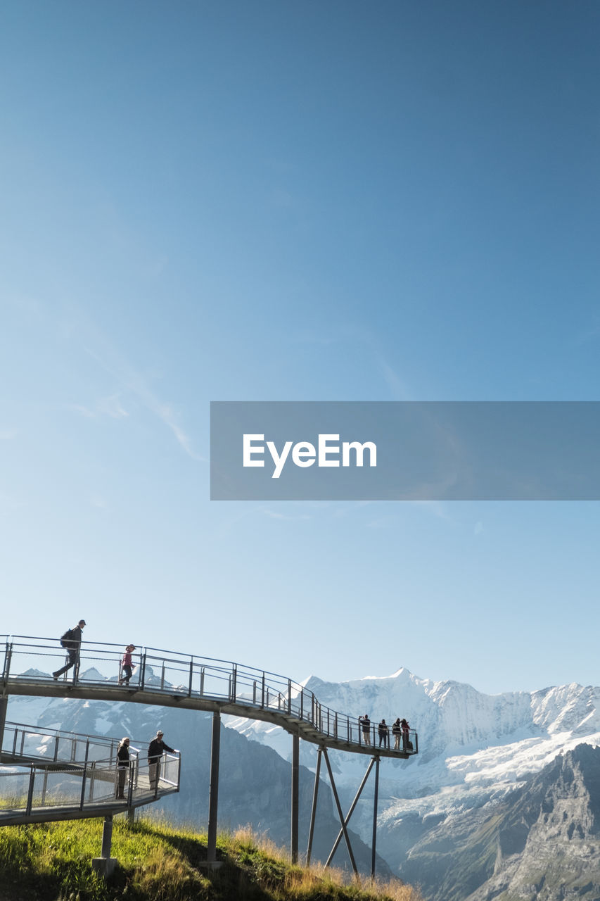 Scenic view of mountains against clear blue sky