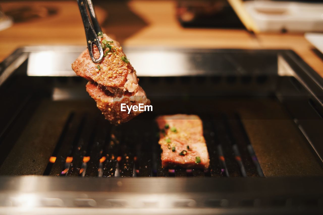 Close-up of meat on barbecue grill