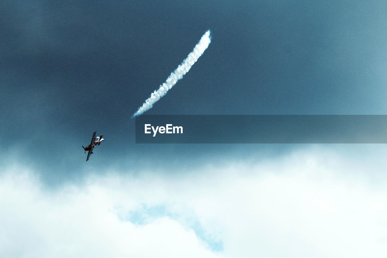 Low angle view of airplane flying against sky