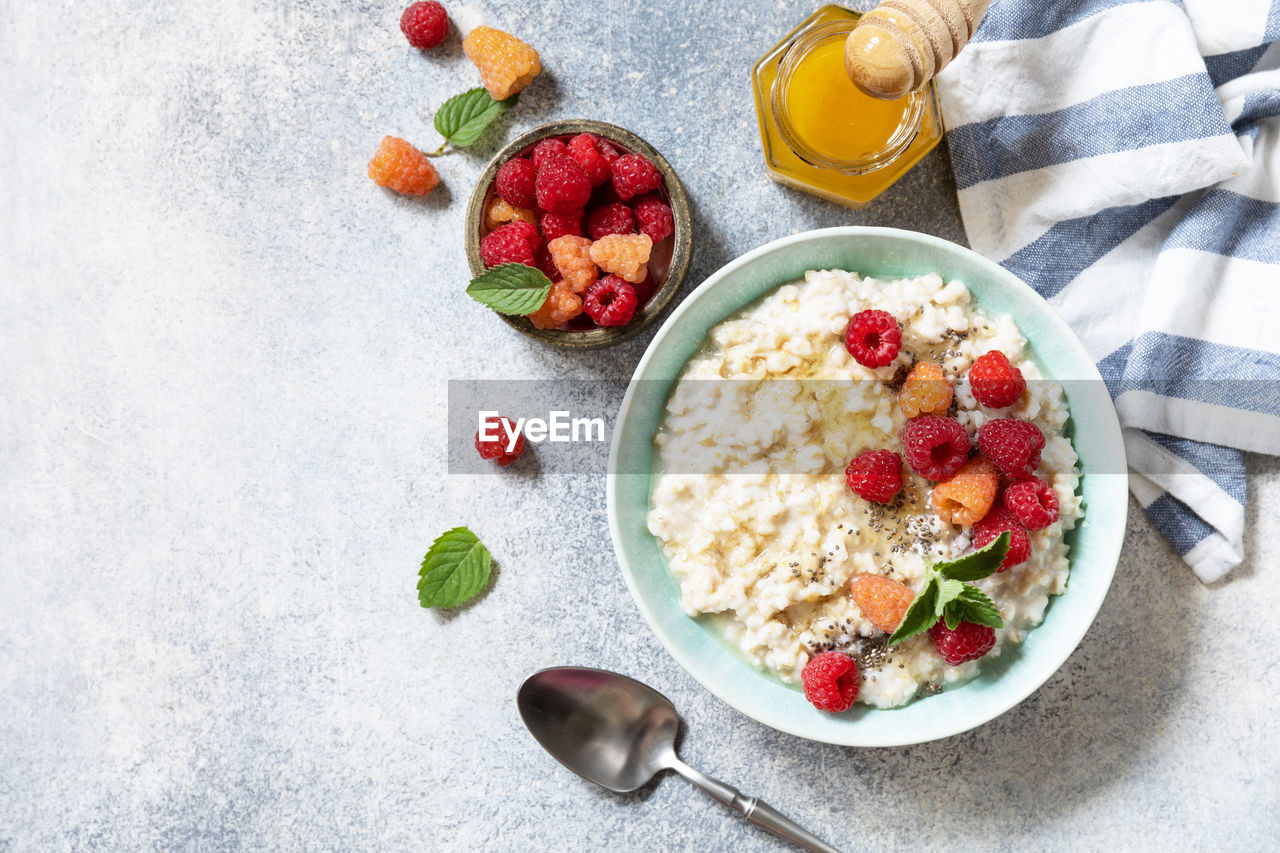 Healthy diet breakfast. oatmeal porridge in ceramic bowl decorated with fresh berries raspberries. 