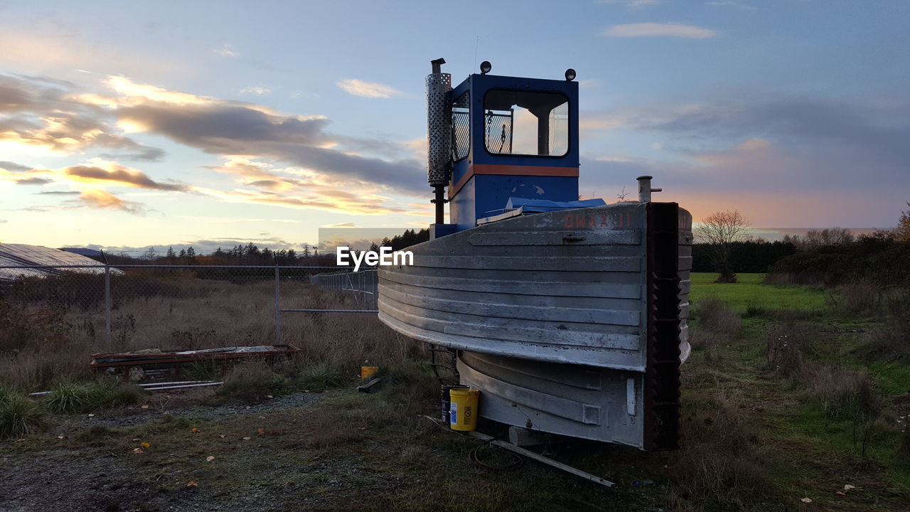 BUILT STRUCTURE ON FIELD AGAINST SKY