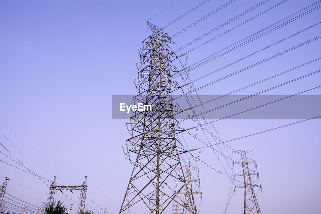 LOW ANGLE VIEW OF POWER LINES AGAINST CLEAR SKY