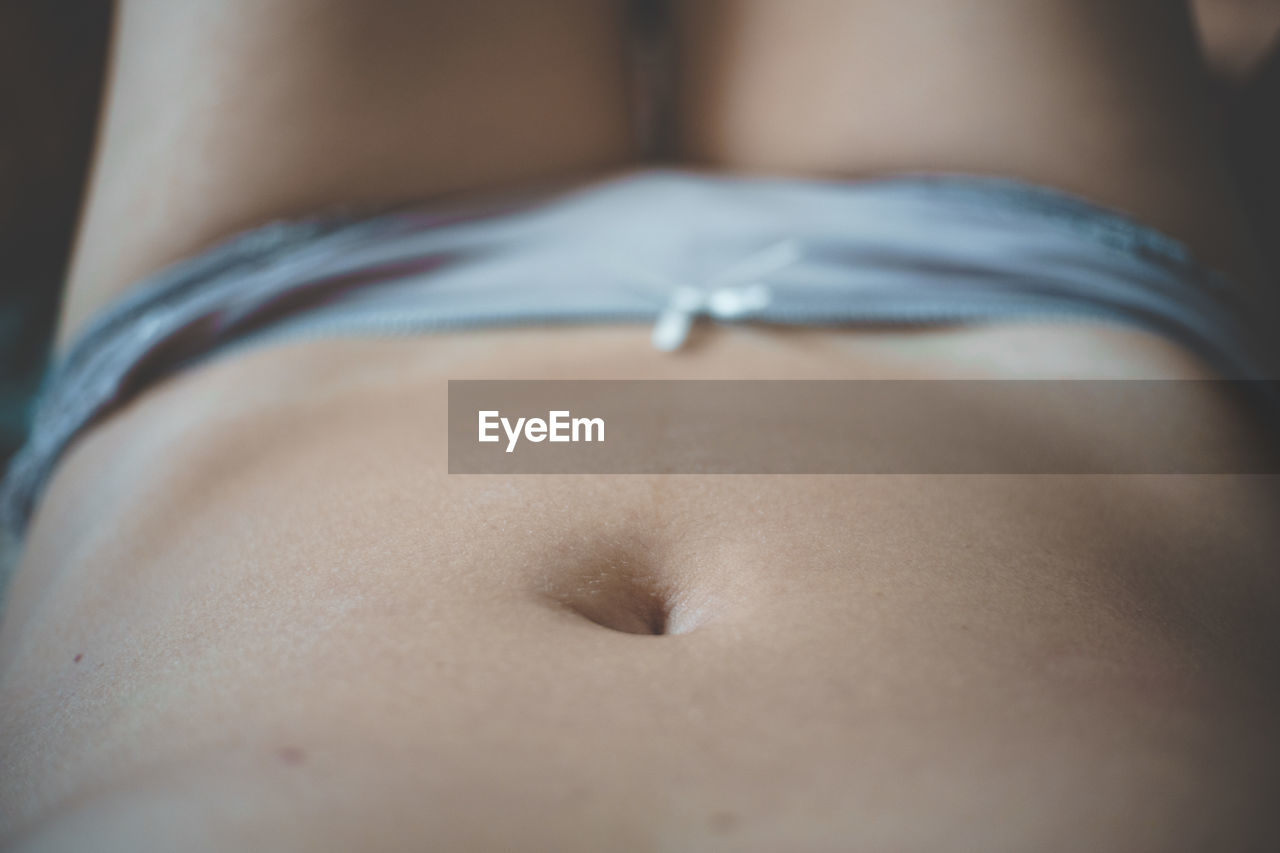 Close-up of woman lying down on floor