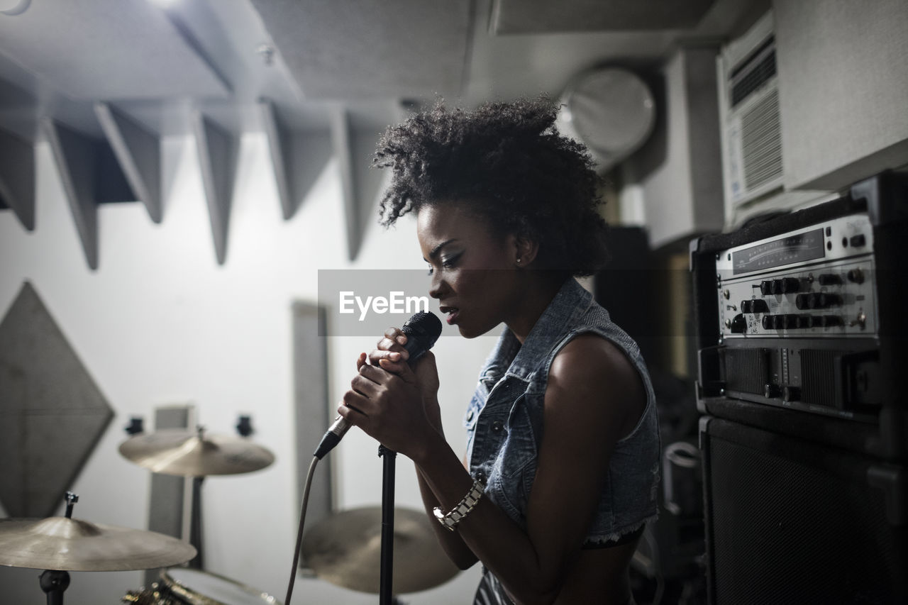 Young singer performing in a studio