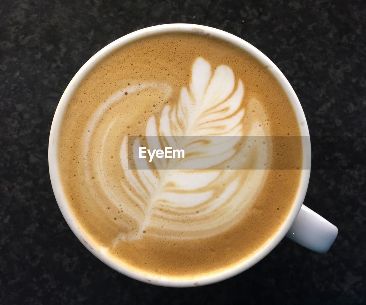 Directly above shot of cappuccino served on table