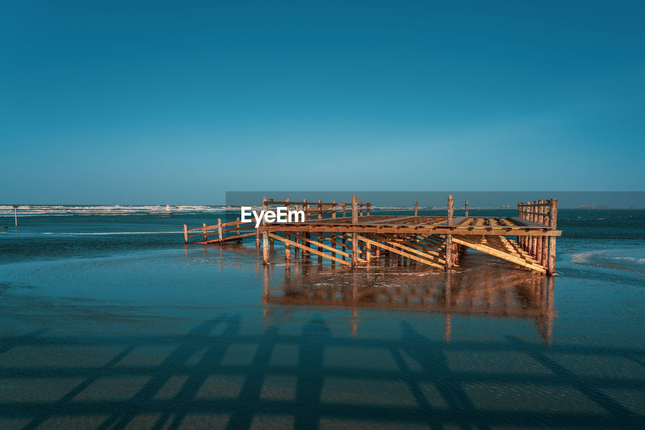 Pile dwelling on the norsee beach of sankt peter-ording in germany