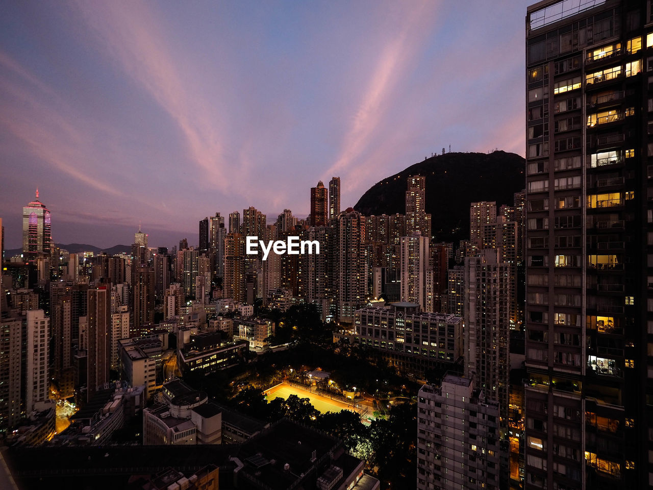 Panoramic view of illuminated buildings against sky at night