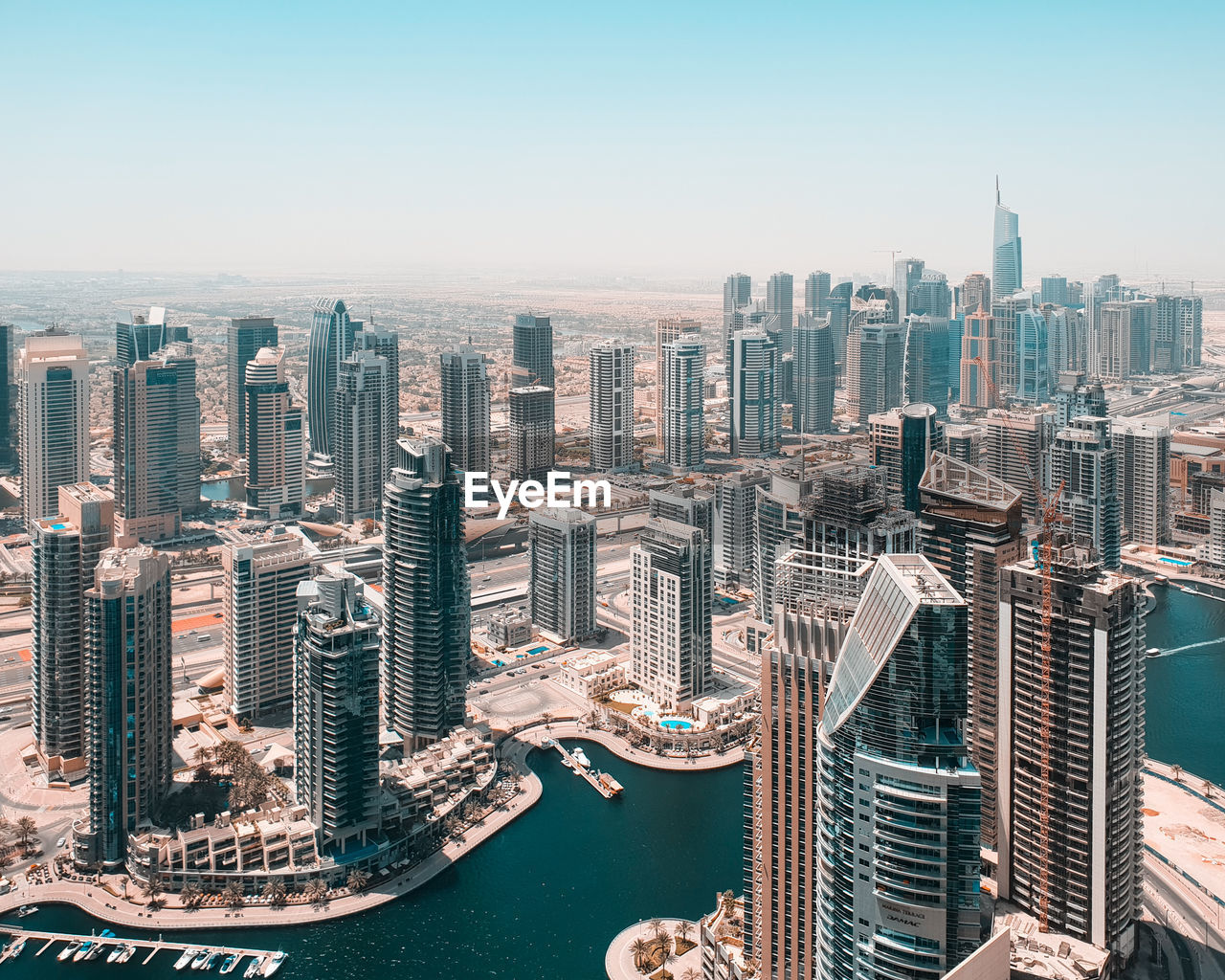 Aerial view of modern city buildings against clear sky