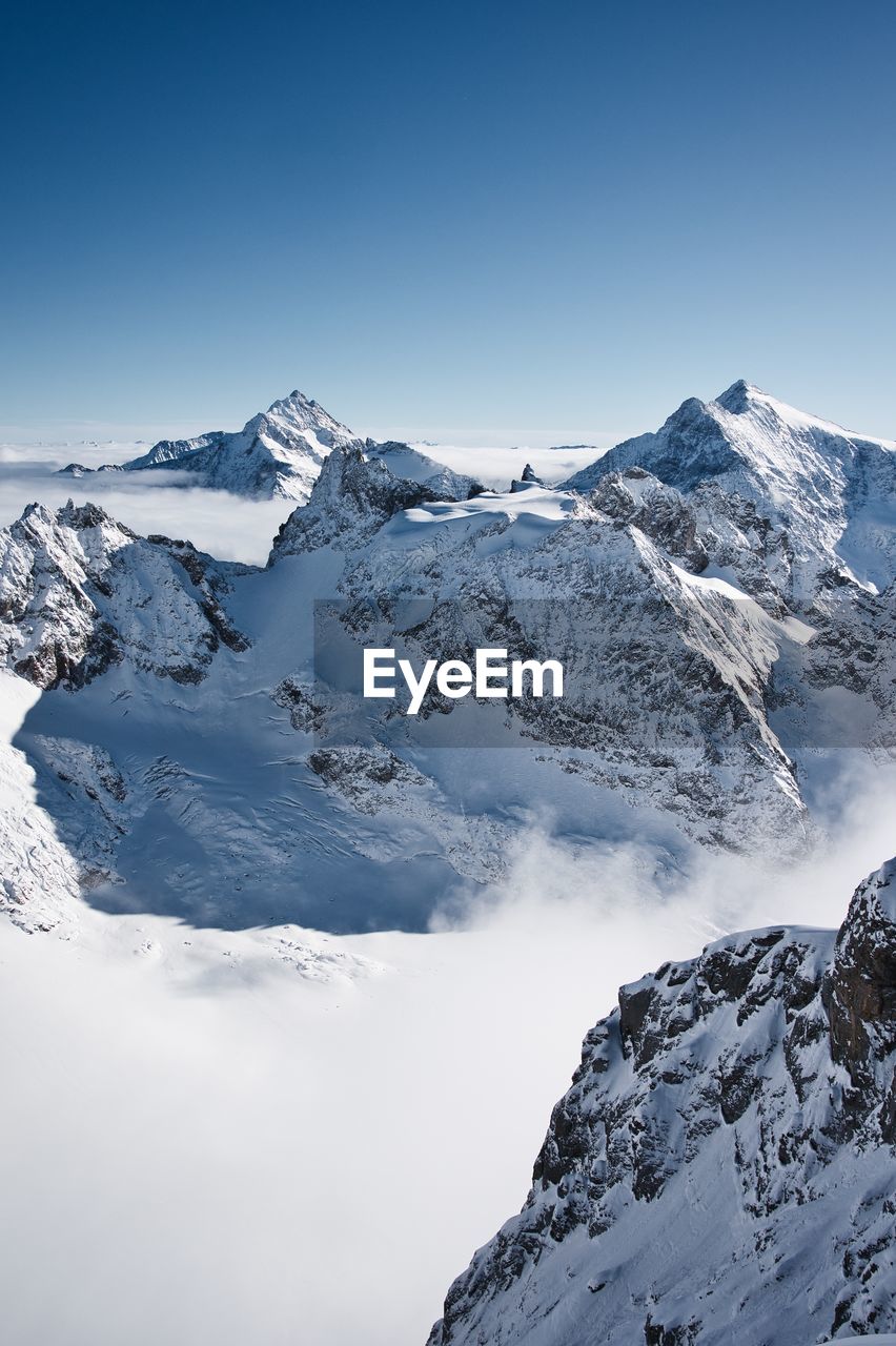 Scenic view of snowcapped mountains against clear sky