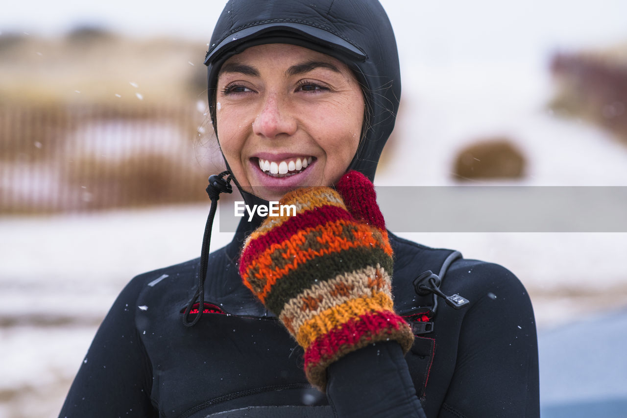 Young woman enjoying winter surfing in snow