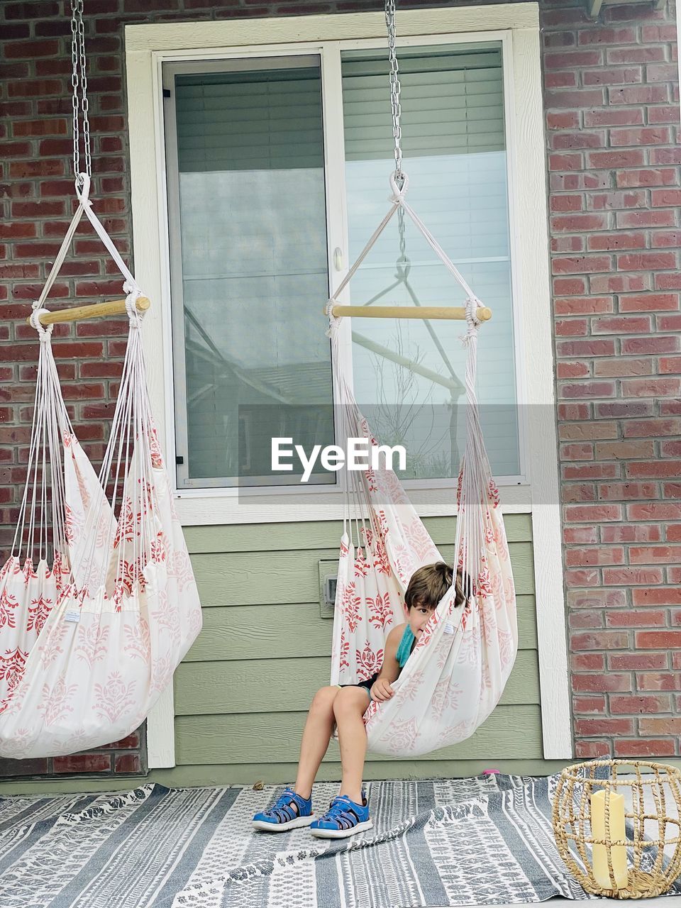 Full length of boy hanging outside building