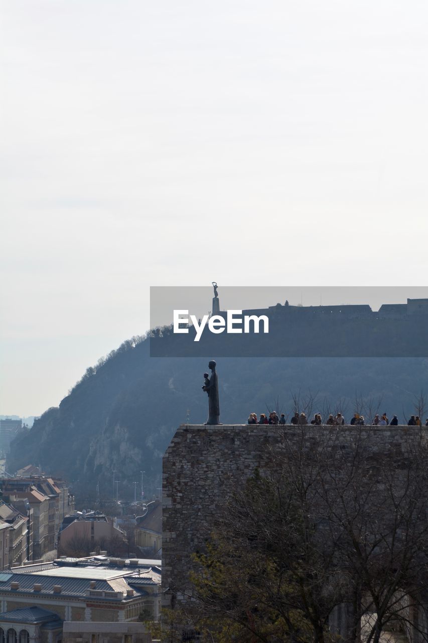 Buildings on mountain against sky