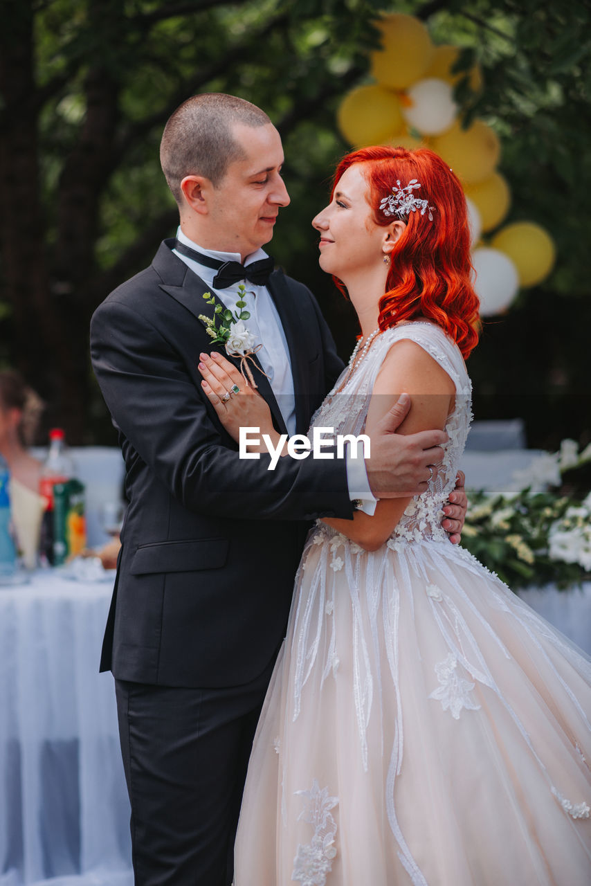 Rear view of couple holding hands