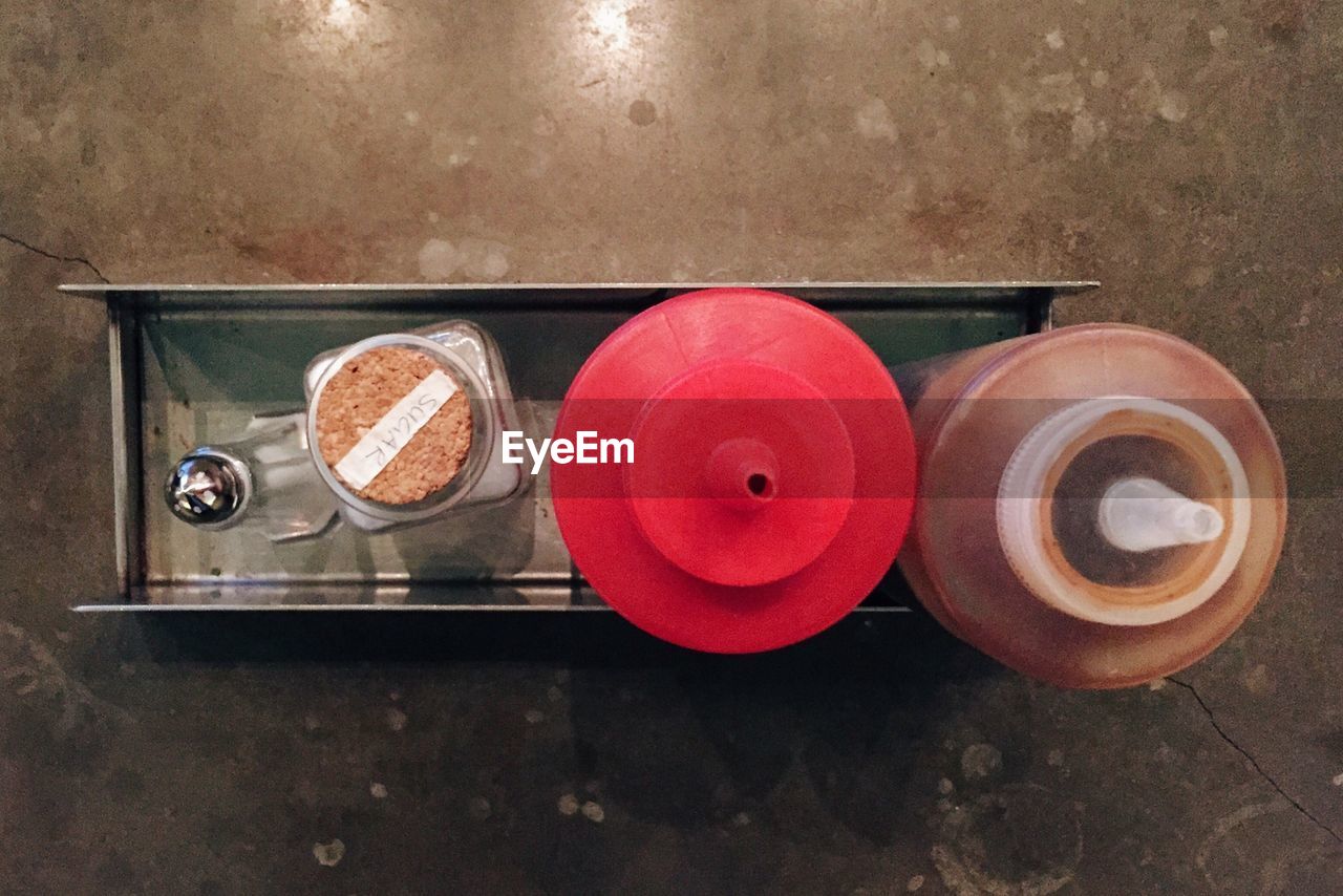 High angle view of condiments in steel rack