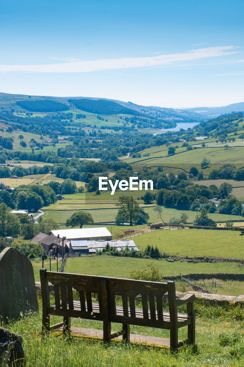 Scenic view of field and mountains against sky