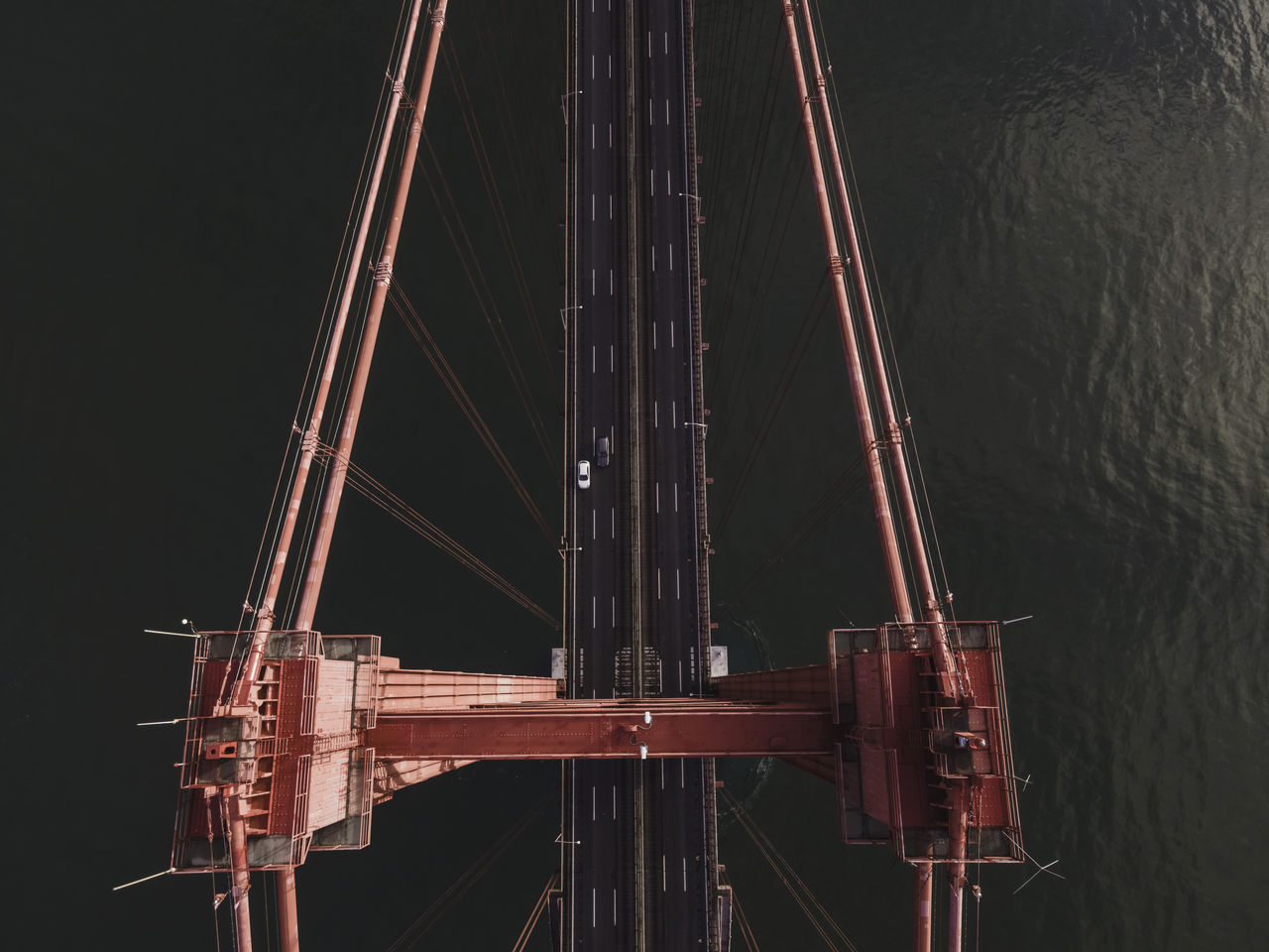 PANORAMIC VIEW OF ILLUMINATED BRIDGE OVER CITY AT NIGHT