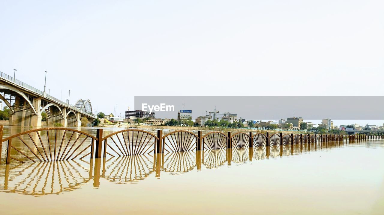 BRIDGE OVER RIVER AGAINST CLEAR SKY