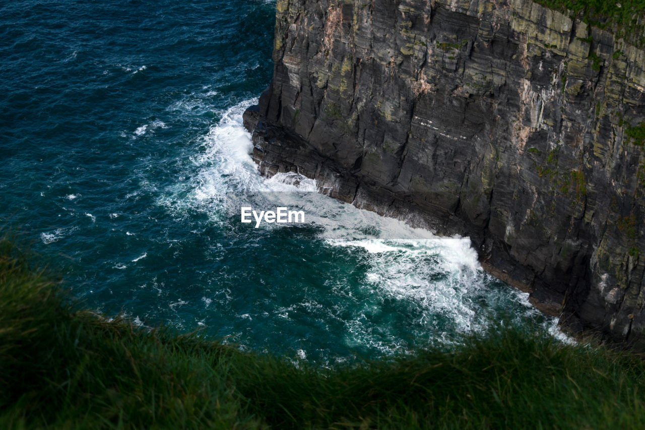 High angle view of sea by cliff