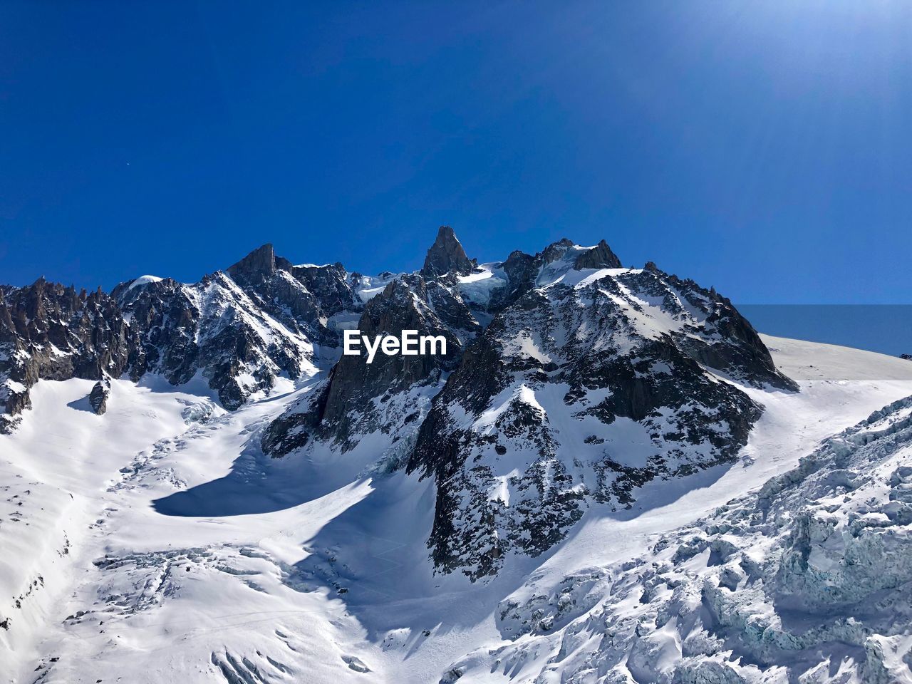 SNOWCAPPED MOUNTAIN AGAINST BLUE SKY