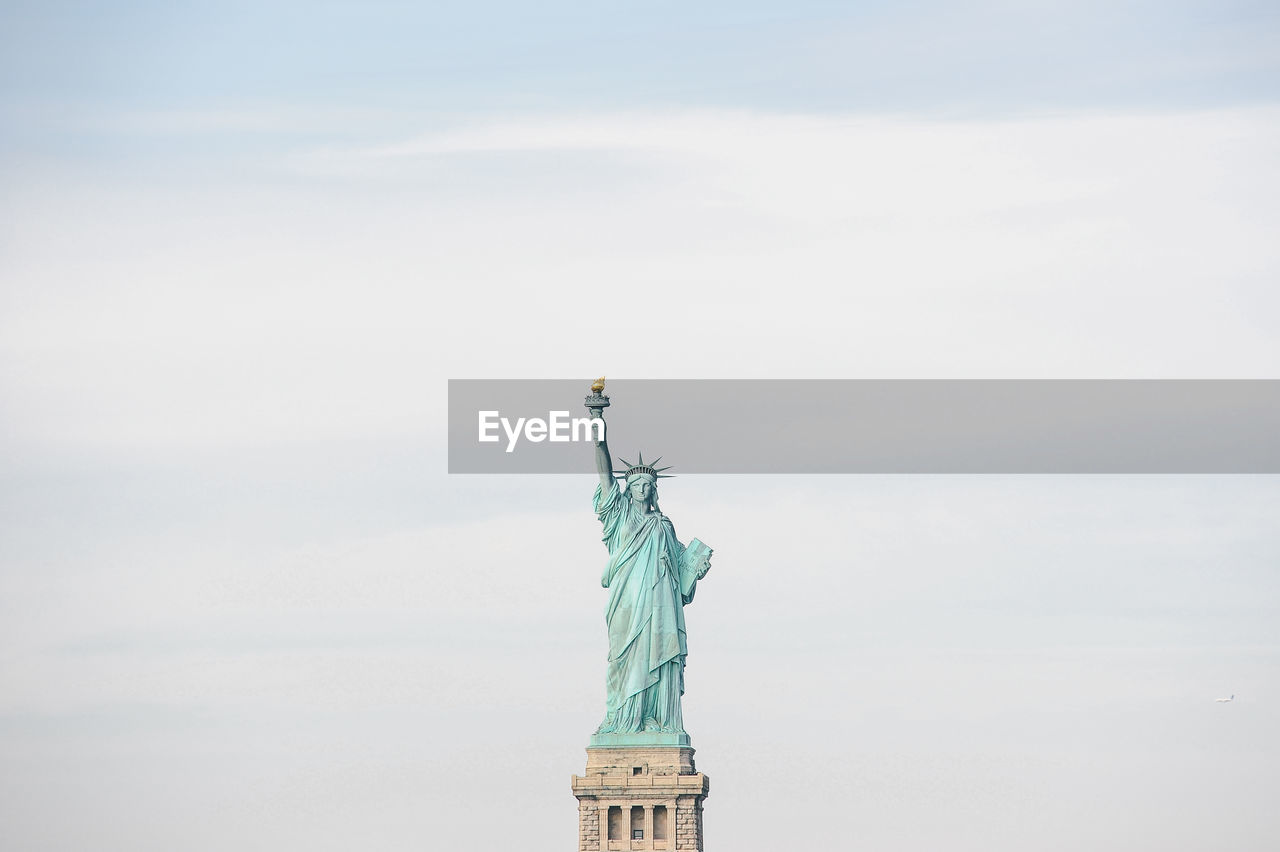 Statue of liberty against cloudy sky